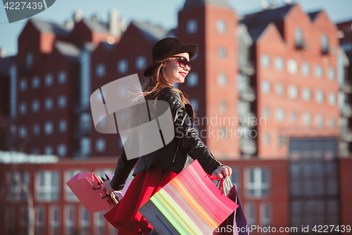 Image of The girl walking with shopping on city streets