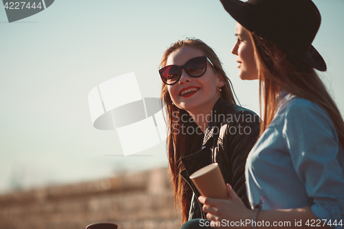 Image of Two girls walking with shopping on city streets