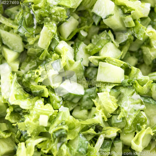 Image of Green salad of cucumbers, lettuce, onions and parsley