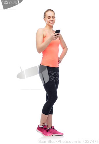 Image of happy smiling sportive young woman with smartphone