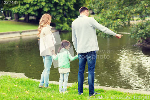 Image of family walking in summer park