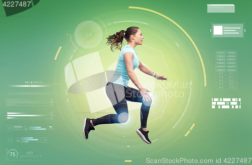 Image of happy smiling sporty young woman jumping in air