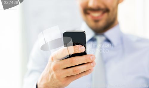 Image of close up of businessman with smartphone