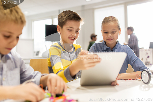 Image of kids with tablet pc programming at robotics school