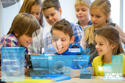 Image of group of school kids with tablet pc in classroom