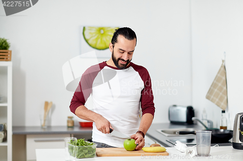 Image of man with blender and fruit cooking at home kitchen