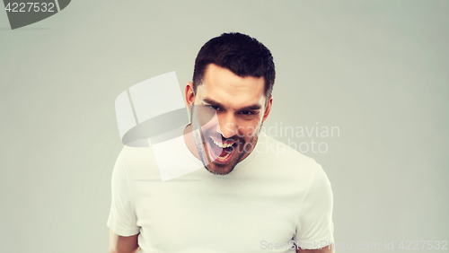 Image of angry man over gray background