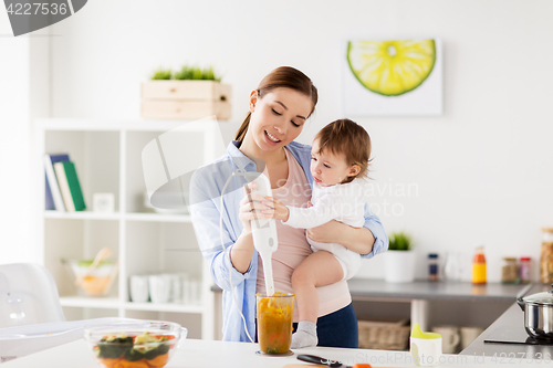 Image of happy mother and baby cooking food at home kitchen