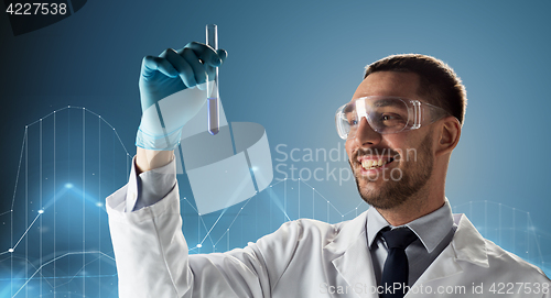 Image of scientist in goggles with test tube and diagram