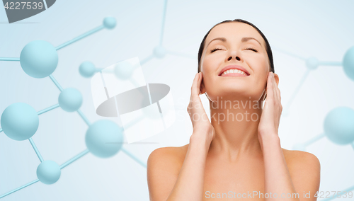 Image of beautiful young woman face with molecules