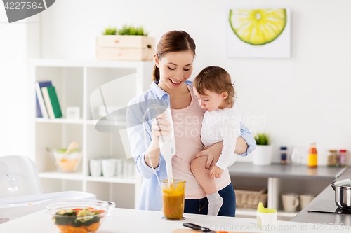 Image of happy mother and baby cooking food at home kitchen