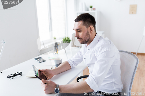Image of businessman with tablet pc at office