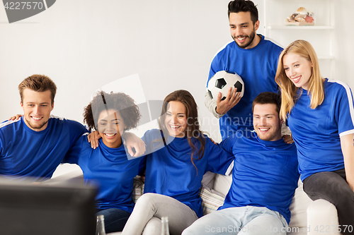 Image of friends or football fans watching soccer at home