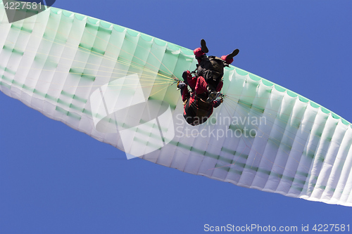 Image of Paragliding in tandem, extreme sport, free gliding and blue sky 