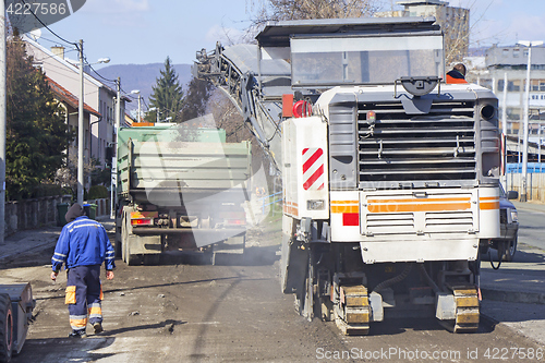 Image of Removed the old asphalt pours from the conveyor belt road millin