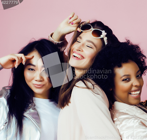 Image of different nation girls with diversuty in skin, hair. Asian, scandinavian, african american cheerful emotional posing on pink background, woman day celebration, lifestyle people concept 