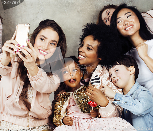 Image of Lifestyle and people concept: young pretty diversity nations woman with different age children celebrating on birth day party together happy smiling, making selfie. African-american, asian and caucasi