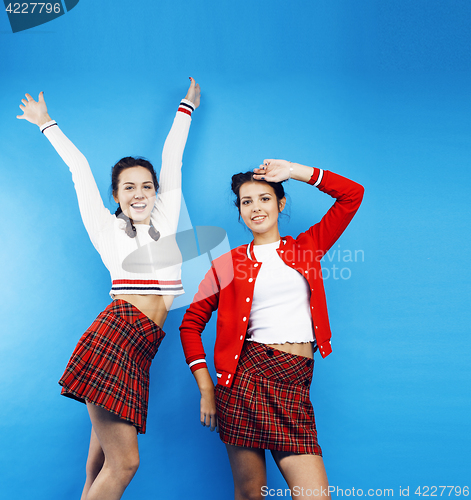 Image of best friends teenage school girls together having fun, posing emotional on blue background, besties happy smiling, lifestyle people concept 
