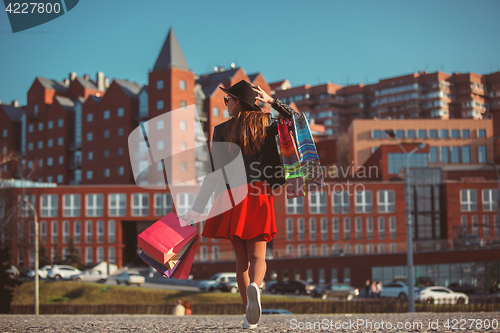 Image of The girl walking with shopping on city streets