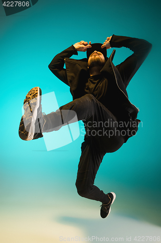 Image of The silhouette of one hip hop male break dancer dancing on colorful background