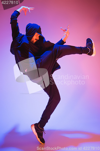 Image of The silhouette of one hip hop male break dancer dancing on colorful background