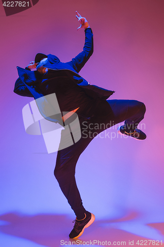 Image of The silhouette of one hip hop male break dancer dancing on colorful background