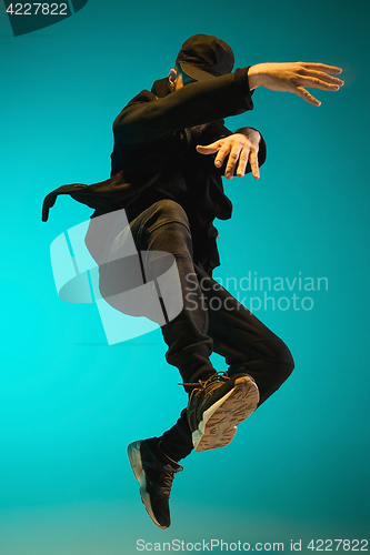 Image of The silhouette of one hip hop male break dancer dancing on colorful background