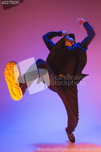 Image of The silhouette of one hip hop male break dancer dancing on colorful background