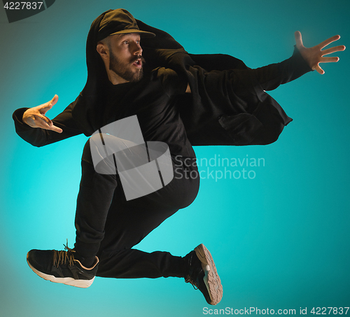 Image of The silhouette of one hip hop male break dancer dancing on colorful background