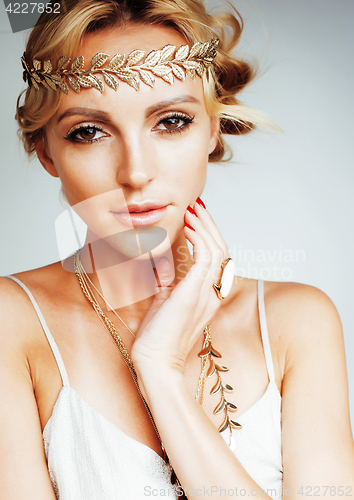 Image of young blond woman dressed like ancient greek godess, gold jewelry close up isolated, beautiful girl hands manicured red nails