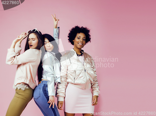 Image of different nation girls with diversuty in skin, hair. Asian, scandinavian, african american cheerful emotional posing on pink background, woman day celebration, lifestyle people concept 