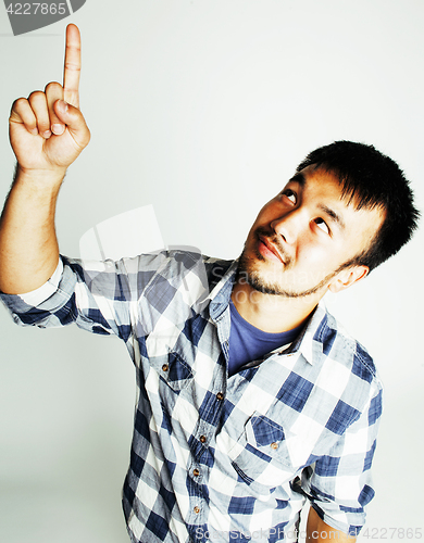 Image of young cute asian man on white background gesturing emotional, po