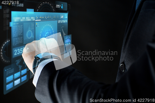 Image of close up of businessman hand with smartwatch