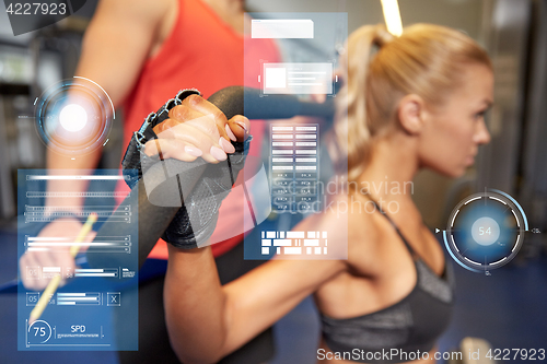 Image of man and woman flexing muscles on gym machine