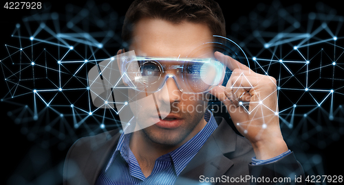 Image of businessman in virtual reality or 3d glasses