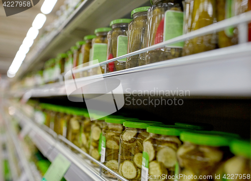 Image of jars of pickles on grocery or supermarket shelves