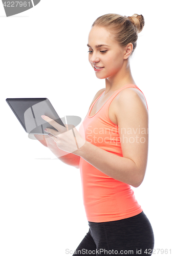 Image of happy smiling sportive young woman with tablet pc