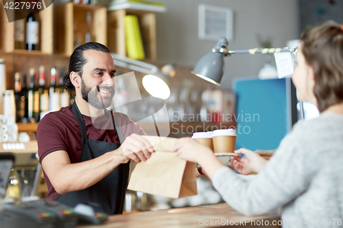 Image of man or waiter serving customer at coffee shop