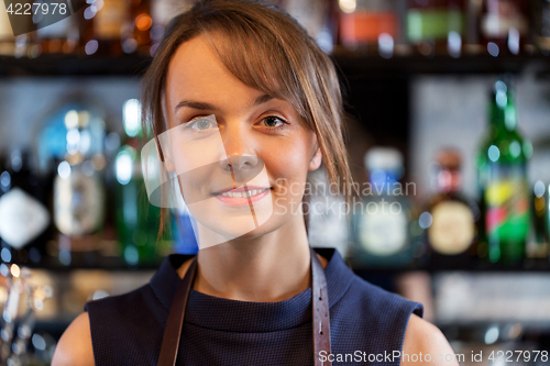 Image of happy smiling barmaid or woman at cocktail bar