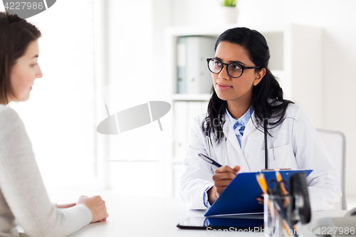 Image of doctor with clipboard and woman at hospital