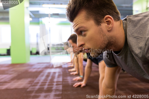 Image of group of people exercising in gym