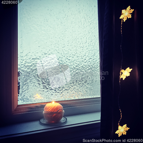 Image of Cozy frosted window and candle light