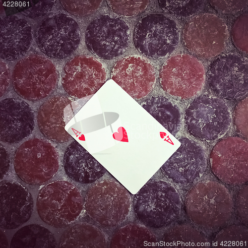 Image of Ace of hearts card on the floor