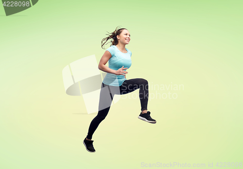 Image of happy smiling sporty young woman jumping in air