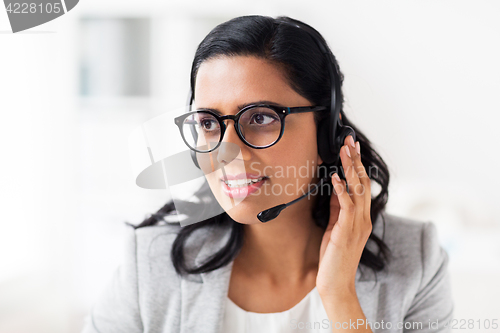Image of businesswoman with headset talking at office