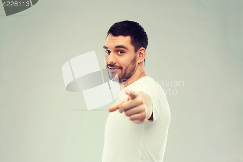 Image of man pointing finger to you over gray background