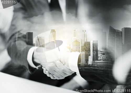 Image of two businessmen shaking hands at office