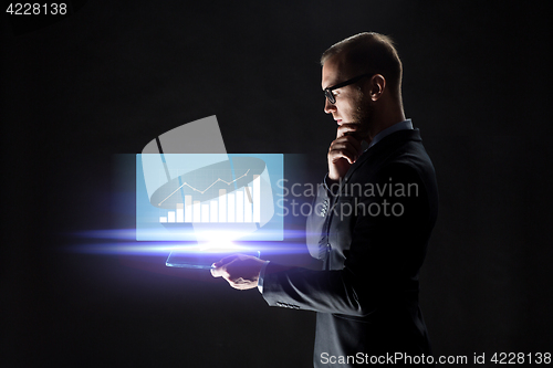 Image of businessman with tablet pc and virtual chart