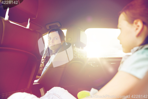 Image of happy family with little child driving in car