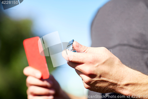 Image of referee with whistle and red card at soccer game